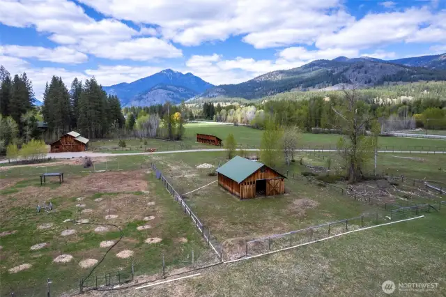 Fenced one-acre garden with rich soil, fruit trees, and wobbler irrigation—adjacent to one of two designated residential building sites