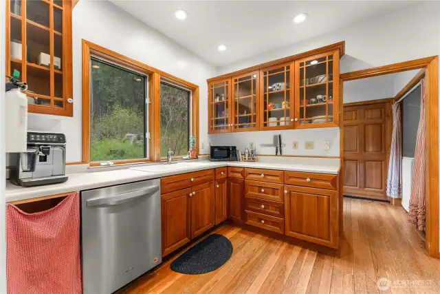 Bright country kitchen with solid wood cabinets glass front uppers—style meets function