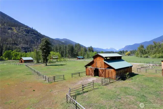 Iconic barn with fenced pasture and mountain backdrop—ready for livestock, storage, or creative use