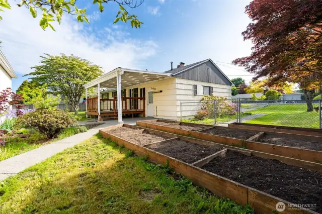 Plant your favorite flowers or veggies in the raised garden beds, perfect for the gardening enthusiast.