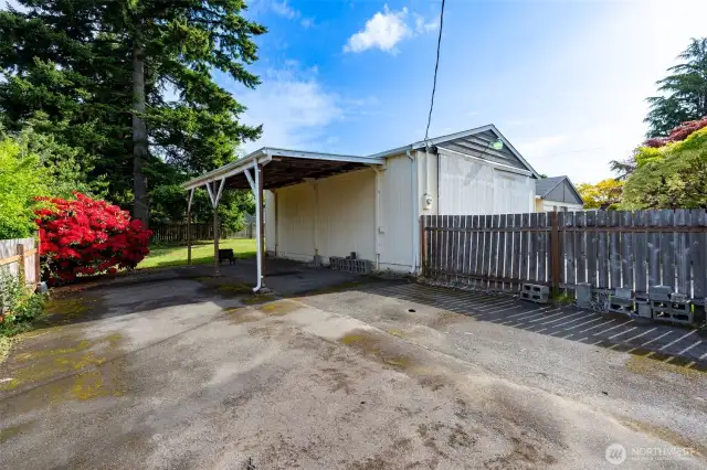 Covered carport and loads of paved parking for RV or boat.