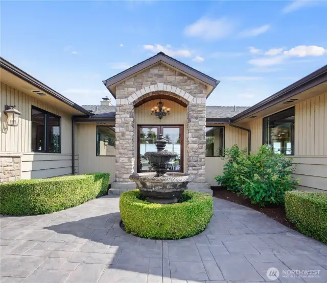 Welcome home to a tranquil entrance featuring a charming fountain that sets the tone for peaceful living