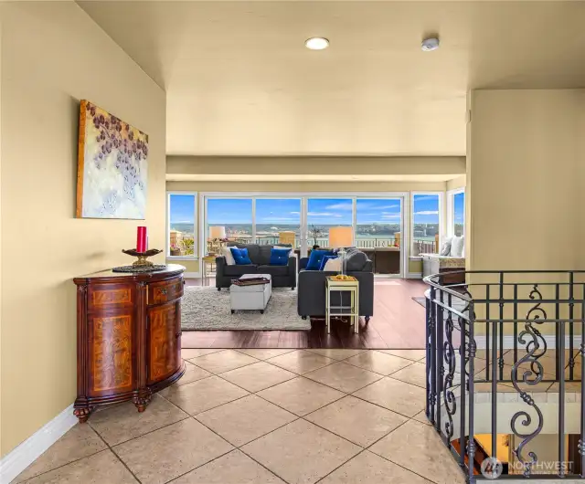 Welcoming entry opens to a stunning living room with a fireplace and expansive windows that capture breathtaking views in every season.