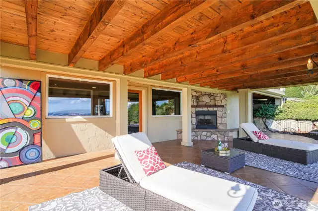 Enjoy outdoor living with a covered patio on the lower level, complete with a gas fireplace for cozy gatherings and relaxing evenings.