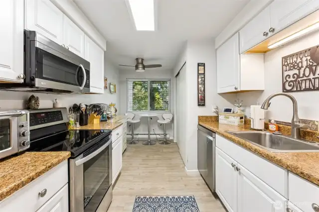 Quaint eating area in the kitchen feels like you're in a park while you enjoy your morning coffee.  The kitchen has a good amount of counter space and storage.  The washer & dryer are tucked away in the closet at the end of the kitchen on the right.