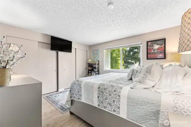 Bedroom with double closets and big enough for a king bed, night stands, and dressers.