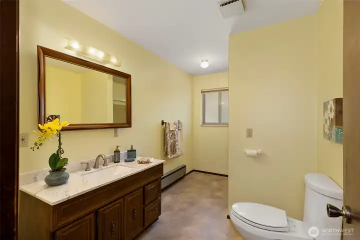 The main floor bathroom has full tub and shower and large vanity.