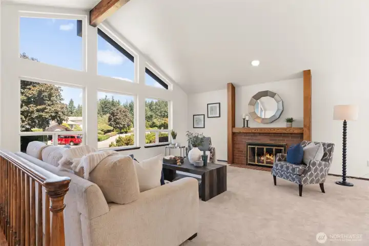 Open living room with fireplace and vaulted ceilings.