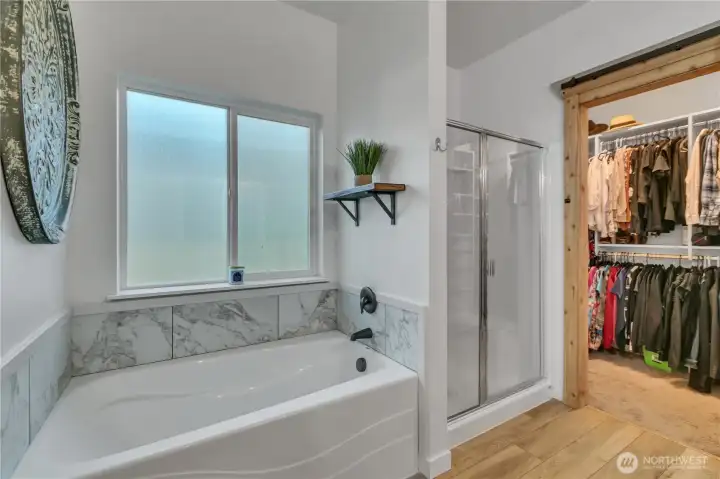 Luxurious soaking tub and standing shower in en-suite primary bath