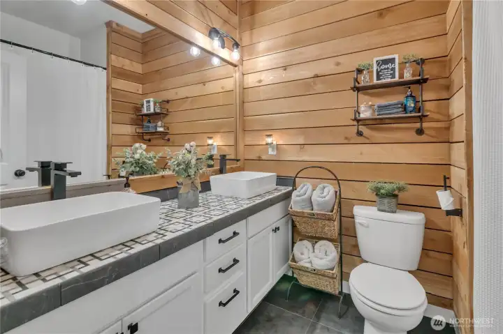 Full main bath with dual vanity and stylish fixtures