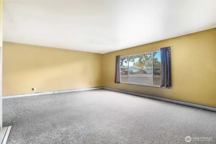 (Tenants furniture removed with AI). Step into a roomy living space filled with natural light.
