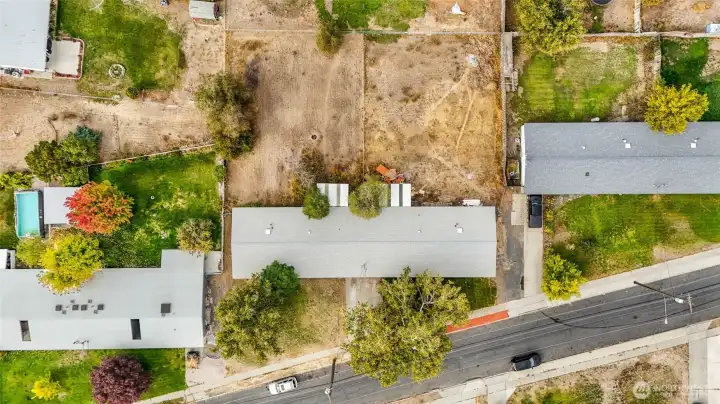 Spacious lot with mature trees and fenced backyard.