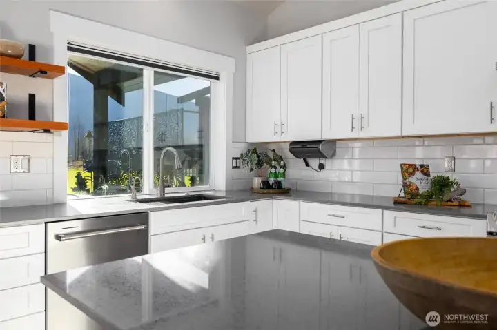 The center island gives plenty of space for dining, storage, baking, entertaining, and meal prep.