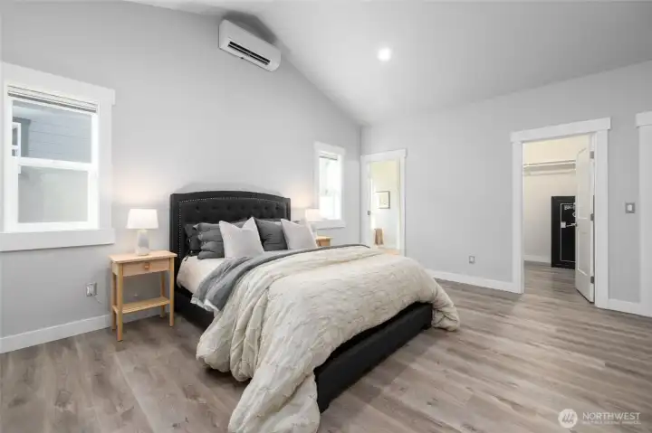 The primary suite with bathroom through the door at the left and the walk-in closet at right.