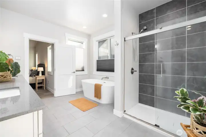 Primary bath, showing the tile surround in the shower and the separate soaking tub.