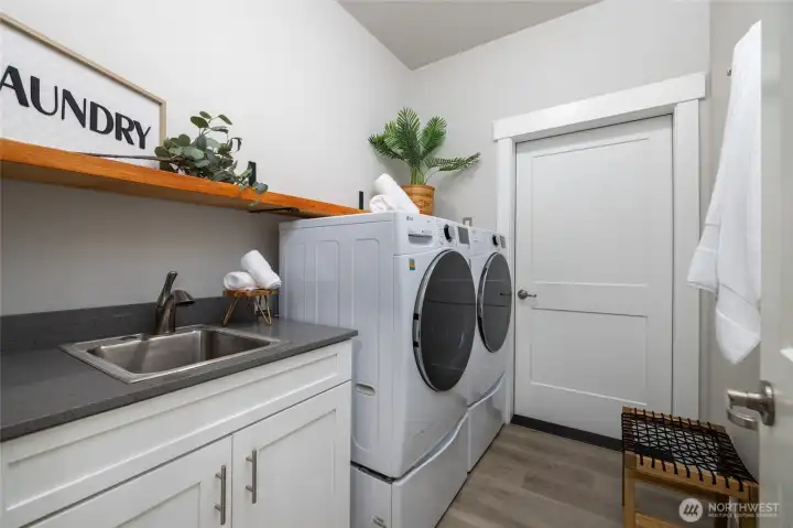 The garage opens into the laundry/utility room.  Utility sink, brook closet, washer, and dryer.