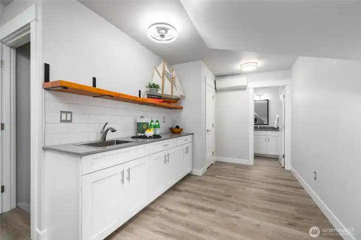 So perfect for entertaining, or for multi-generational living or live-in help, this wet bar area just needs a fridge and hotplate to function as a second kitchen.  Large closet and full bath also shown.