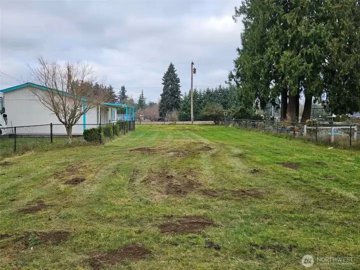 Black chain linked fencing. Parking to the left, with 50amp RV parking and power.