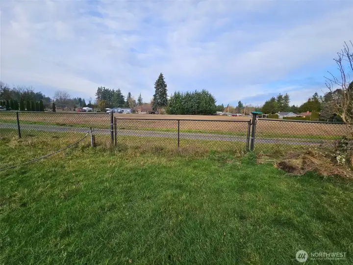 Large 12' gate with easy access off neighboring road.