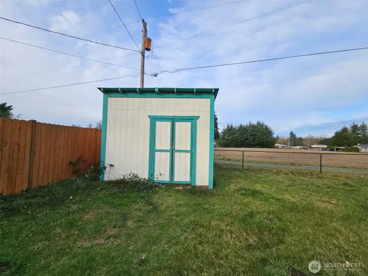 Shed tucked away in corner of property.