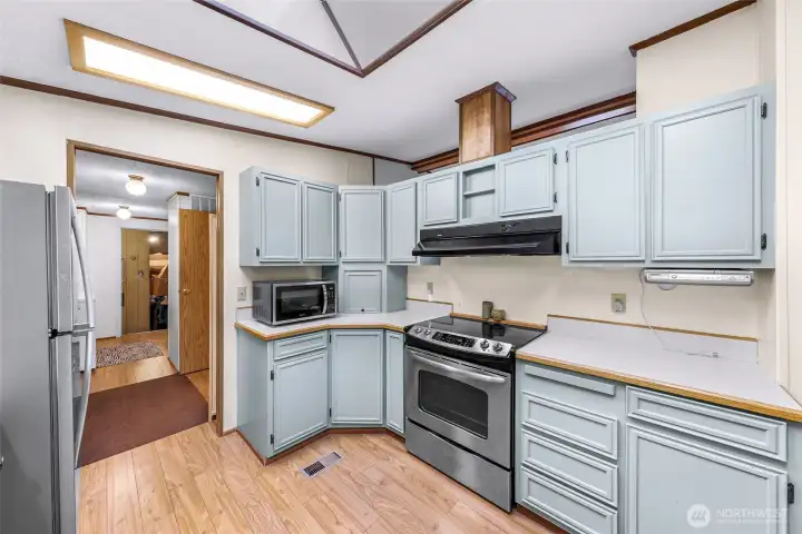 Kitchen and hallway to the left takes you to the laundry room, a pantry and the garage.