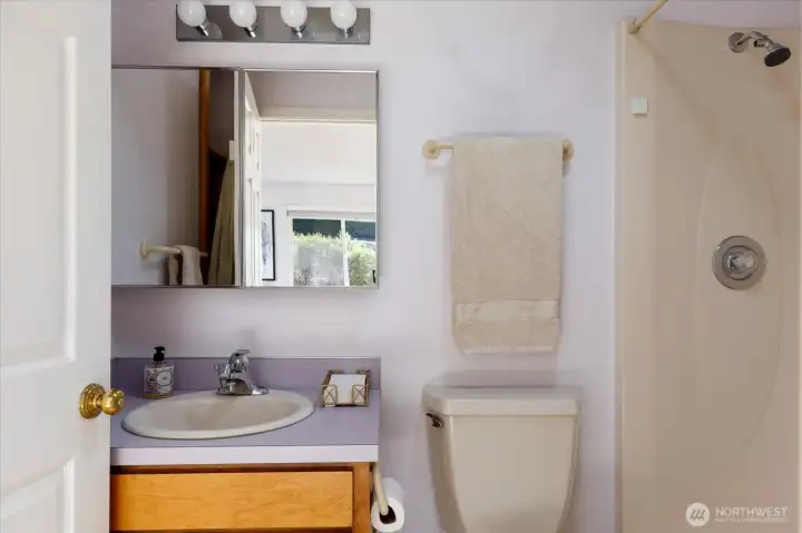 A tidy primary makes the most of the area. There's a linen closet tucked behind the door.