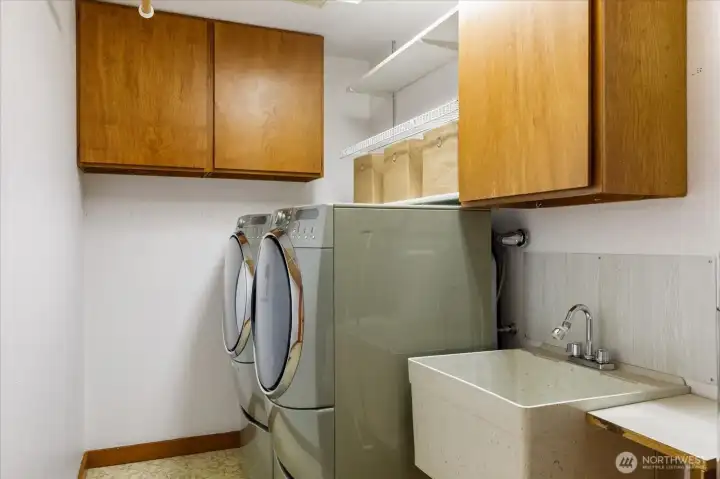 A large laundry room with wash sink.