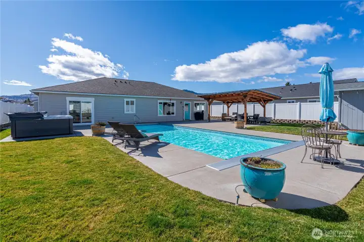 Resort-style backyard retreat featuring a private pool and covered outdoor entertaining area.