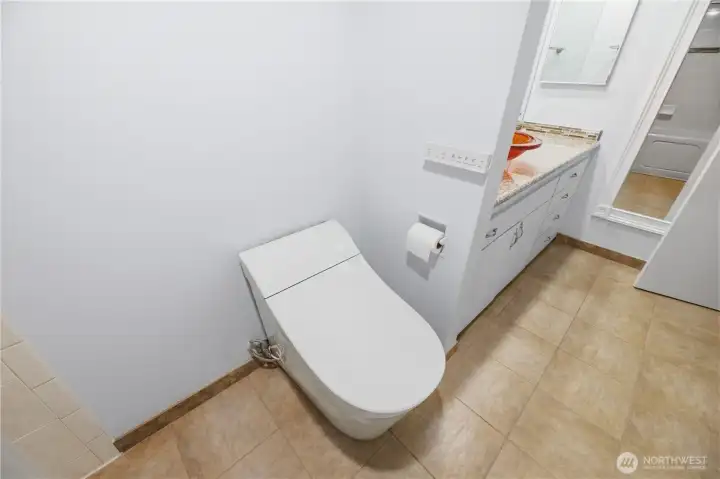Luxury Toilet with Electronic Controls upstairs, off Primary Bedroom.