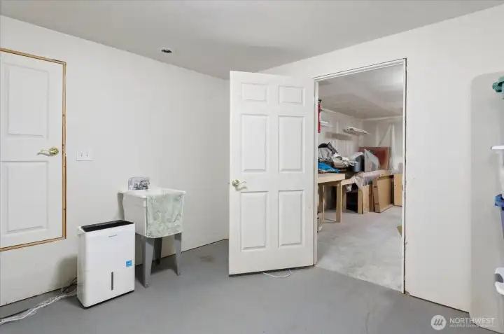 Basement with large crawlspace access, shop ready for projects, and plenty of extra storage.