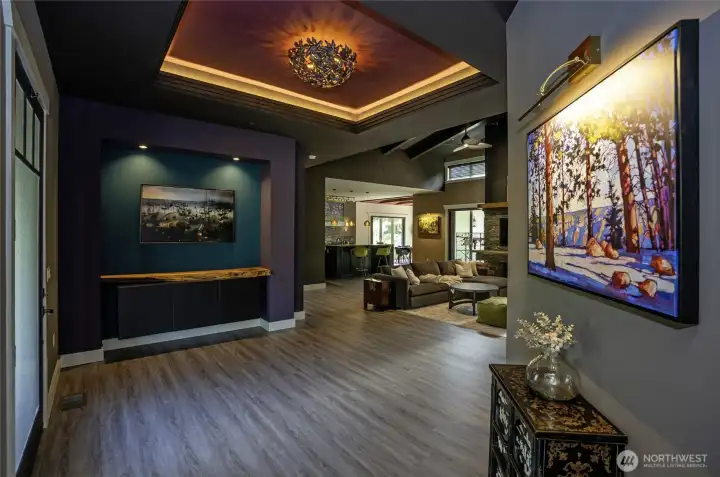 An entryway designed to welcome. From the striking architectural tray ceiling and custom live-edge built-in to the artfully lit galleries, this foyer sets a sophisticated tone for a spectacular open-concept home.