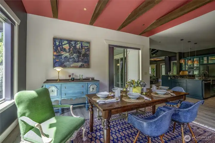 Beneath vaulted ceilings with exposed beams and sun-drenched light, this grand dining space comfortably hosts 12+ guests in effortless style, with seamless flow to the kitchen and living spaces, perfect for elevated entertaining.