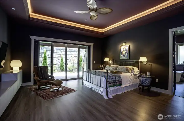 Dramatic design meets modern comfort. This remarkably spacious primary suite offers endless versatility for custom layout and design, creating a grand personal sanctuary that flows seamlessly out to a private, beautifully landscaped yard.