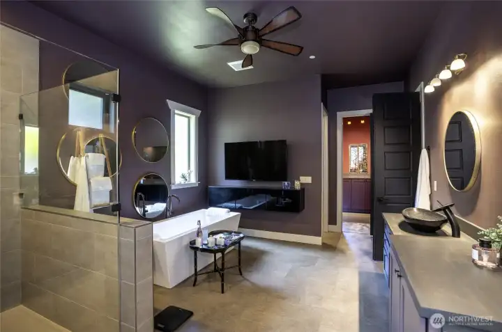 Anchored by sleek floating media cabinetry, this layout transforms your evening—allowing you to unwind in the extra-long, insulated soaking tub while enjoying films in total privacy.