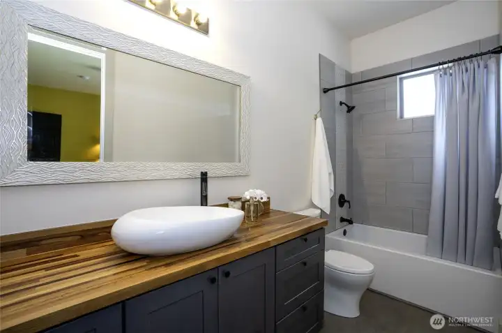Designed with both style and functionality in mind, this private bathroom perfectly complements the bedroom it exclusively serves.