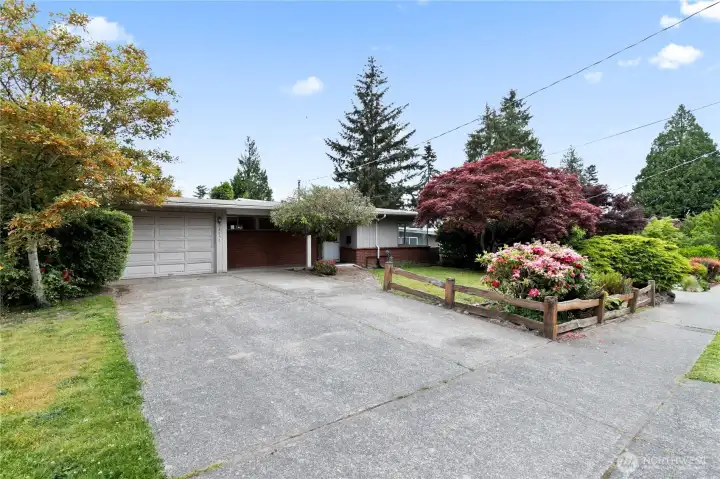 A three-forth frontal view, showing the front yard's foliage, which was recently professionally trimmed A three-forth frontal view, showing the front yard's foliage, which was recently professionally trimmed