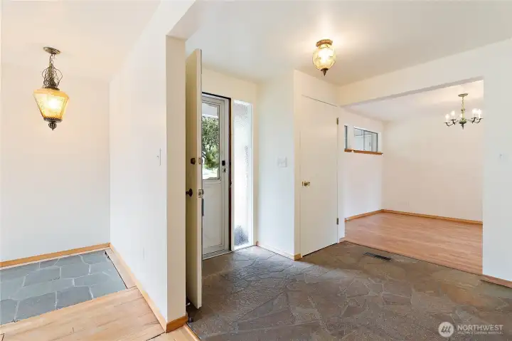 A great view of the slate floored entry, the stone floor insert in the living room, and the hardwood floored dining room A great view of the slate floored entry, the stone floor insert in the living room, and the hardwood floored dining room