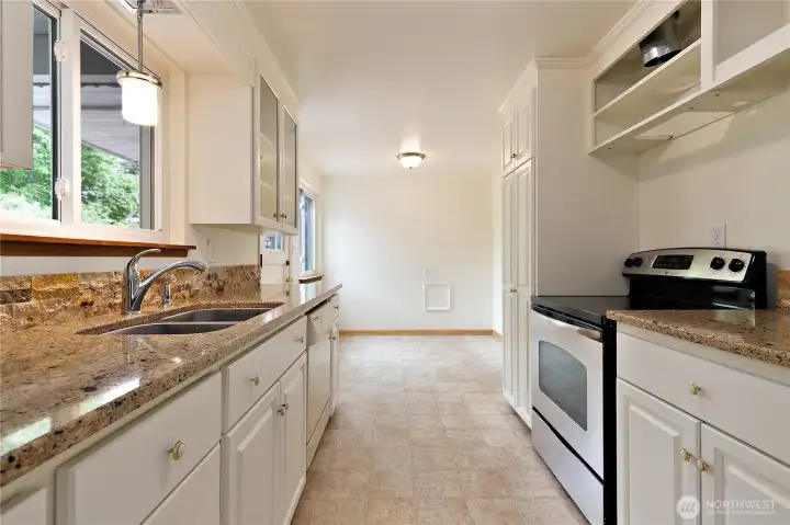 Another view of the kitchen, with the granite counters and rock backsplashes. Another view of the kitchen, with the granite counters and rock backsplashes.