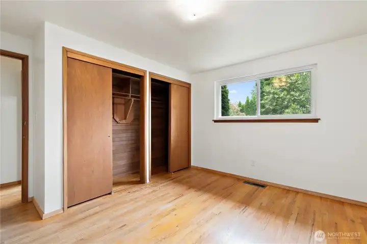 A hardwood floored bedroom, with a dual-sided ceder lined closet A hardwood floored bedroom, with a dual-sided ceder lined closet