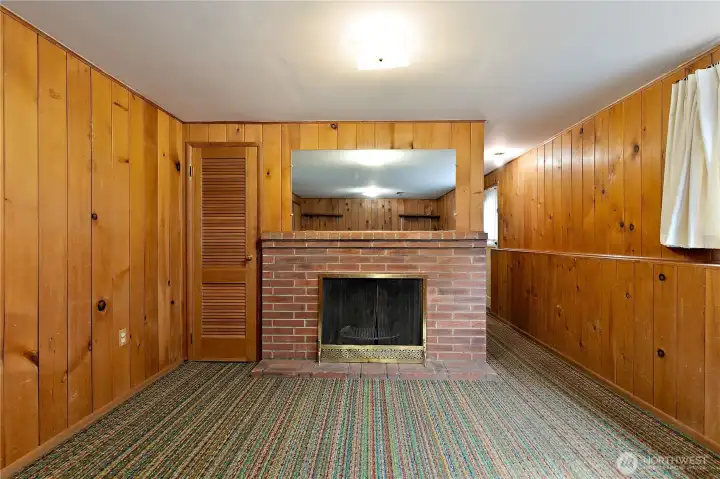 The basement rec room features wall to wall carpeting, and a wood fireplace The basement rec room features wall to wall carpeting, and a wood fireplace