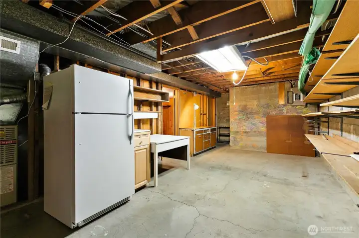 The unfinished utility/laundry area; the refrigerator and furniture will remain with the home. The unfinished utility/laundry area; the refrigerator and furniture will remain with the home.