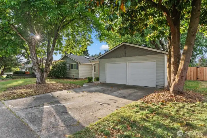 Driveway & Garage – Oversized 4-car garage with room for vehicles, storage, hobbies, or workshop space.