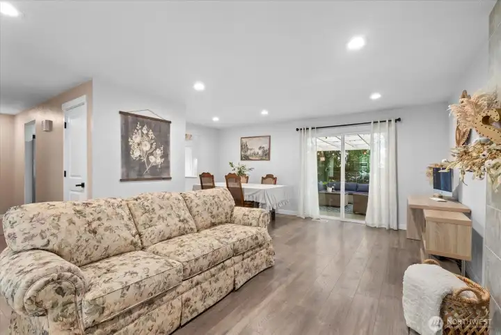 Spacious living room with views of the backyard and easy access to outdoor living areas.