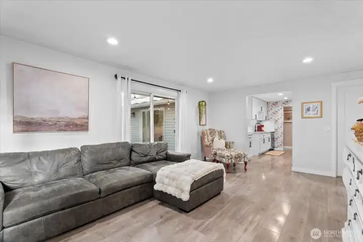 Spacious living room with views of the backyard and easy access to outdoor living areas.
