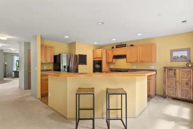 Large kitchen with breakfast bar allows for mingling, or informal dining!