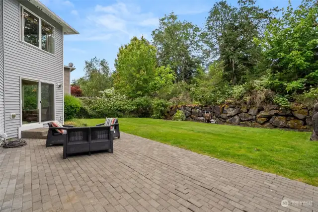 Large backyard with brick patio backs up to green space for the ultimate in privacy!