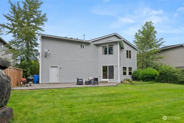 Back of home.  Oversized garage has the convenience of a utility door to access the backyard.