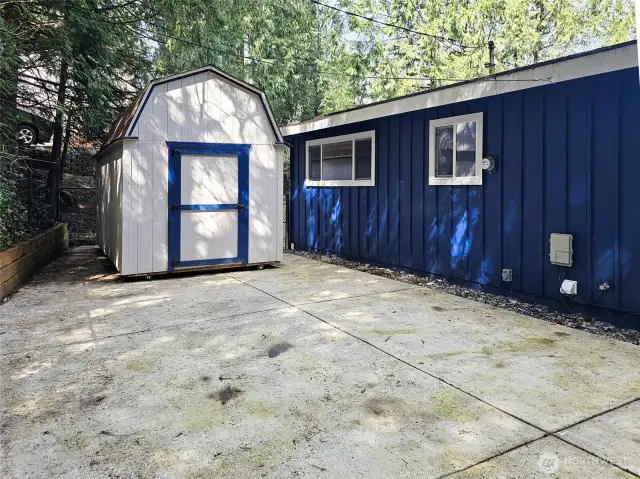 Rear patio and outbuilding.