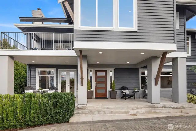 Sophisticated modern design showcases clean lines, covered front porch, view deck, and distinctive copper door, accented by professional landscaping!