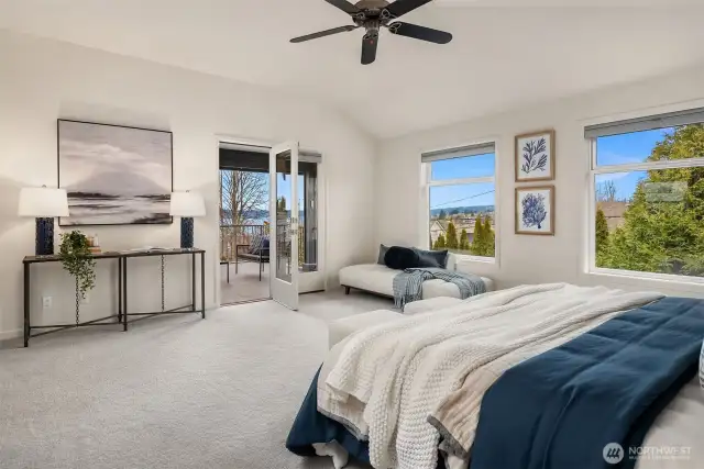 Wake up to tranquil Lake Washington views in this luxurious primary suite, featuring a private deck for sunset viewing.